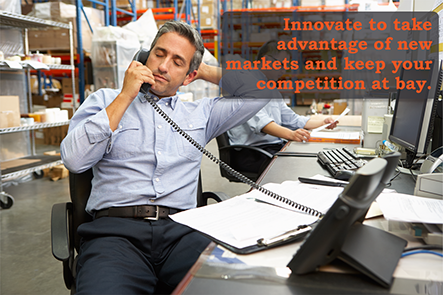 stock-photo-businessman-working-at-desk-in-warehouse-129612782b